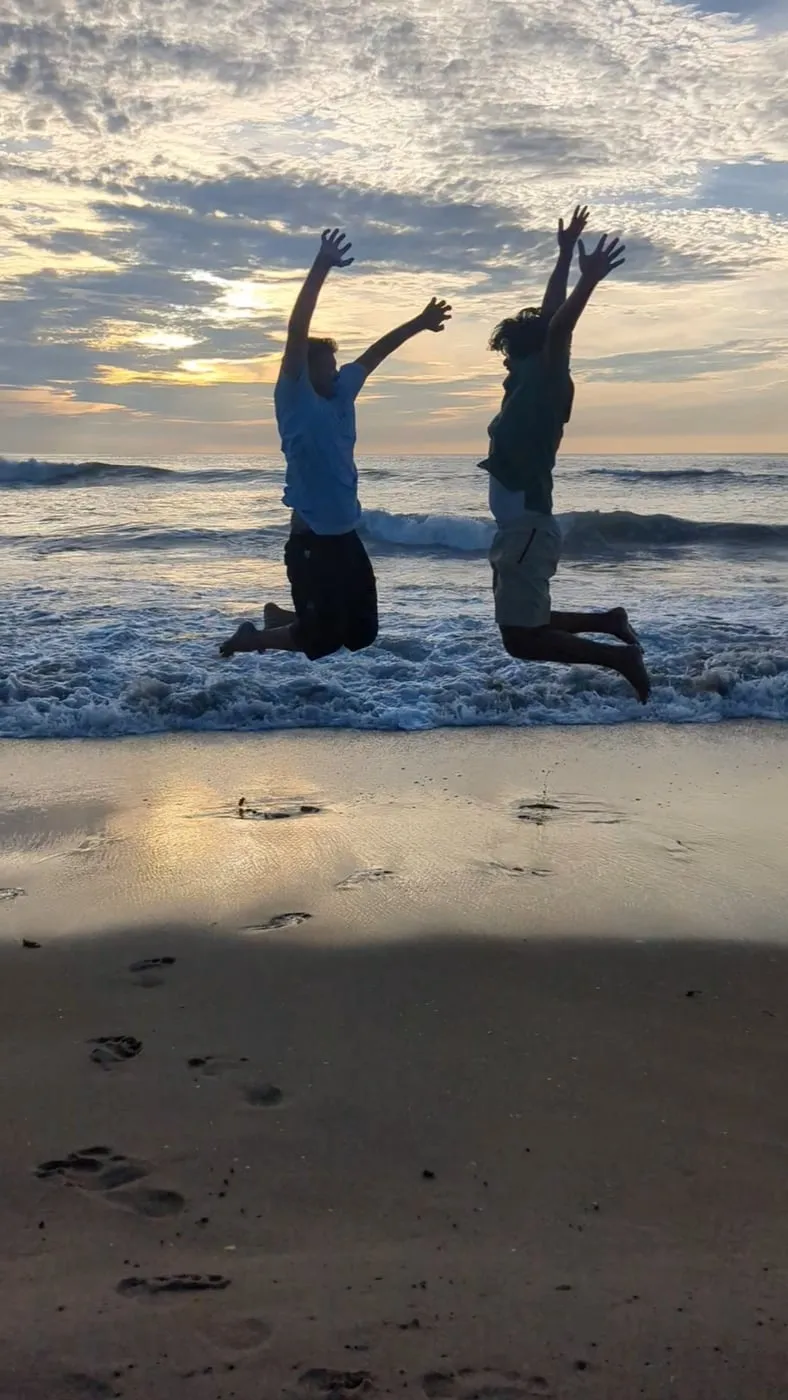 Mid-jump at the beach